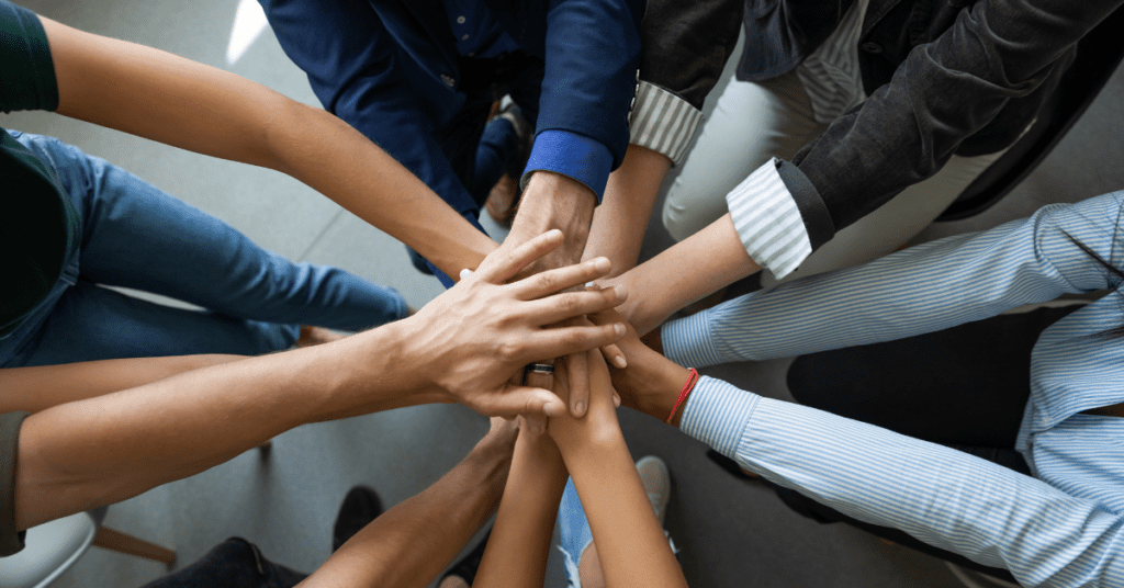 Team huddle at work (employee engagement)